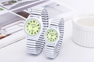 Close-up of couple's watches with light green dials and white elastic metal straps