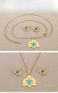 Detail of gold orchid jewelry set with green zircon necklace and matching earrings