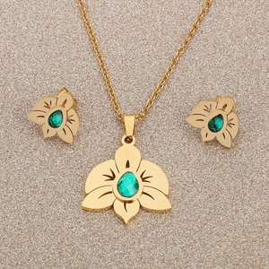 Elegant gold orchid jewelry set with green zircon stones featuring necklace and earrings