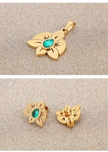 Detail of gold flower jewelry set with green zircon stones, pendant and stud earrings