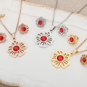 Hollow floral titanium steel jewelry set with red crystal in rose gold, silver, and gold
