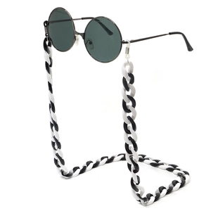 Retro round sunglasses with bold black and white acrylic chain on white background
