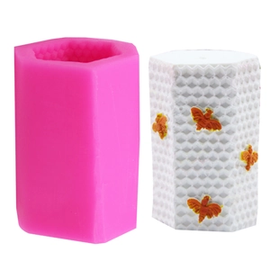 Detail of hexagonal honeycomb silicone cake mold with decorative 3D bee decorations