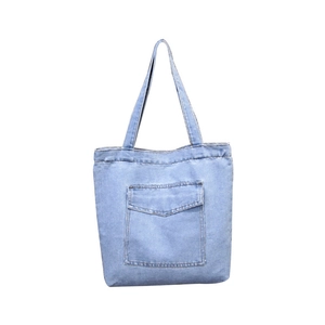 Light blue denim tote bag with large front pocket and long straps on white background