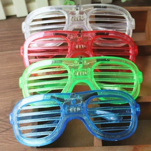 LED light-up shutter glasses in four colors on a wooden display for parties