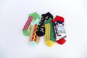 Detailed flat lay of cotton low cut socks featuring colorful novelty food and space patterns