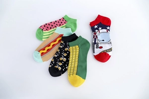 Detailed flat lay of five creative patterned ankle socks with watermelon and NASA motifs