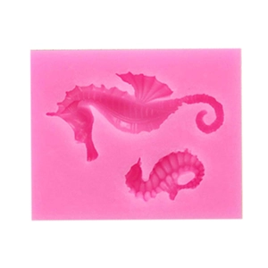Detailed view of pink silicone mold with two seahorse shapes for chocolate making