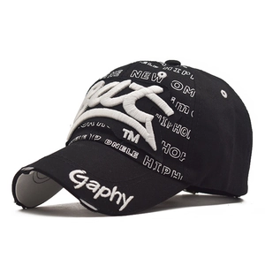 Detail of street-style distressed baseball cap featuring 3D embroidery and woven hip-hop tapes