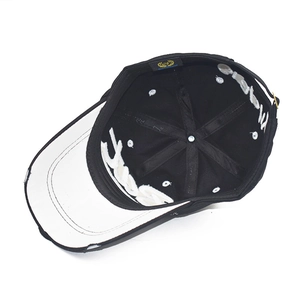 Black distressed baseball cap featuring interior white embroidery and gold buckle adjustment