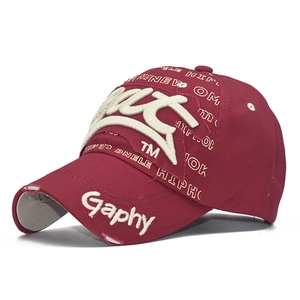 Detailed view of the distressed brim with 3D embroidery on this burgundy baseball cap