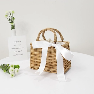 Handwoven square straw handbag with a white satin bow for summer beach leisure style