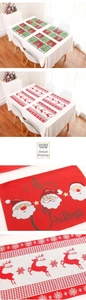 Macro detail of Christmas placemats with Santa embroidery and red checkered reindeer patterns