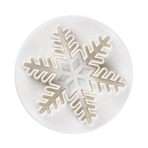 Detailed top view of white plastic snowflake plunger cutter for cookie dough and baking