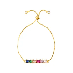Detail of adjustable gold box chain bracelet with colorful rainbow zircon stones