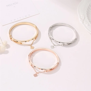 Roman numeral open bangle with heart charm and tassel chain in three metallic finishes