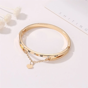Golden Roman numeral cuff bracelet with heart pendant and sparkling zircon accents