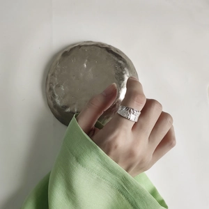 Detail of 925 sterling silver ring with irregular hammered moon surface texture