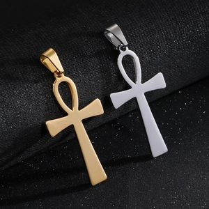 Hip hop Egyptian Ankh cross pendants in gold and silver finish on a textured surface