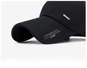 Detailed macro view of the extended visor and metal Sport tag on black cotton baseball cap