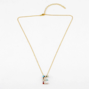 Detail view of gold letter E pendant necklace with colorful cubic zirconia stones
