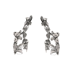 Close-up of vintage leaf ear cuffs in antique silver with detailed vine texture