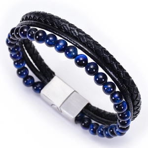 Detail of men's leather braided bracelet with blue tiger eye beads and magnetic buckle