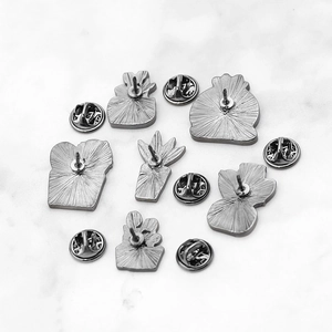 Detailed back view of cactus pins featuring zinc alloy finish and butterfly clasps