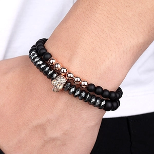 Skull charm beaded bracelet set with black matte stones and rose gold accents