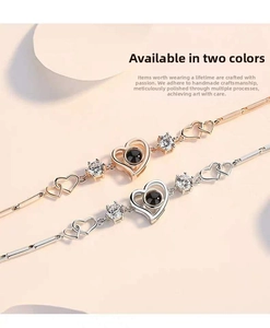 Detail of rose gold and silver heart bracelets with projection stones and zircon floral accents