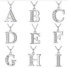 Grid view of nine silver alphabet pendant necklaces with sparkling zircon inlay details