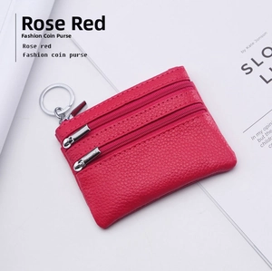 Detail view of rose red pebble leather coin purse with triple zippers and key ring
