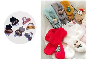 Detail of Christmas plush scarf featuring a soft embroidered reindeer and santa motif