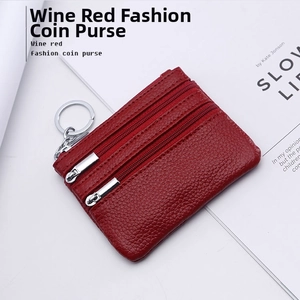 Close-up of wine red pebble grain leather coin purse with three zippers and key ring