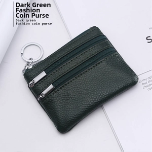 Detail of dark green pebble leather coin purse with three zipper sections and key ring