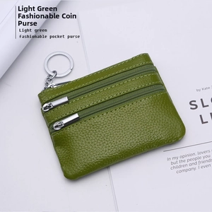 Detail of light green litchi grain leather coin purse with double silver zippers and keychain