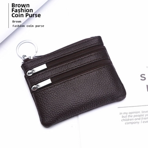 Close-up of dark brown genuine leather coin purse with double zipper and silver keychain