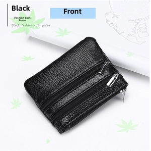 Detail view of black lychee grain leather coin purse with three-layer silver zippers