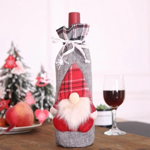 Christmas champagne bottle cover featuring a grey gnome with a red plaid hat