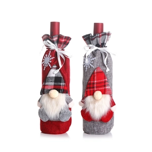 Christmas gnome wine bottle covers in red and grey with snowflake patterns for party decor
