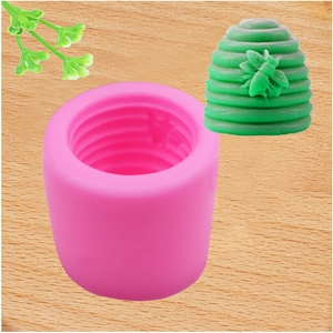 Pink silicone mold for honeycomb and bee design with green wax finished example