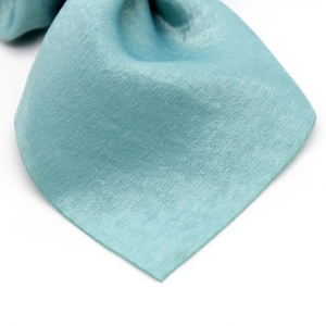 Close-up of light blue satin scrunchie showing fine twill weave texture and silky luster