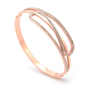 Rose gold stainless steel geometric bangle with multi-row white crystals on white background