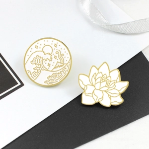 Detail of vintage enamel brooches featuring Ukiyo-e waves and lotus motifs with gold edges