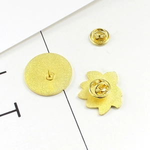 Macro view of butterfly clasp backings and metal pins for vintage lotus brooches