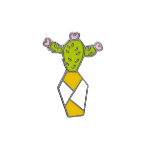 Close-up of green cactus brooch with pink flower and striped pot in enamel finish