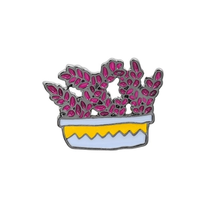Detailed close-up of a purple cactus plant enamel pin with a white and yellow pot design