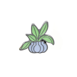 Detail of light green enamel cactus pin in light blue pot with metallic borders
