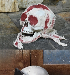 Detail of Halloween bloody skull prop with red gauze used as a practical phone holder