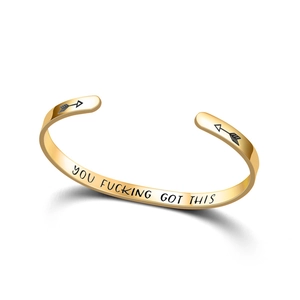 Close-up of gold stainless steel cuff bracelet with YOU FUCKING GOT THIS engraving